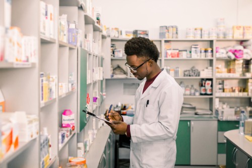 African American pharmacist doing inventory