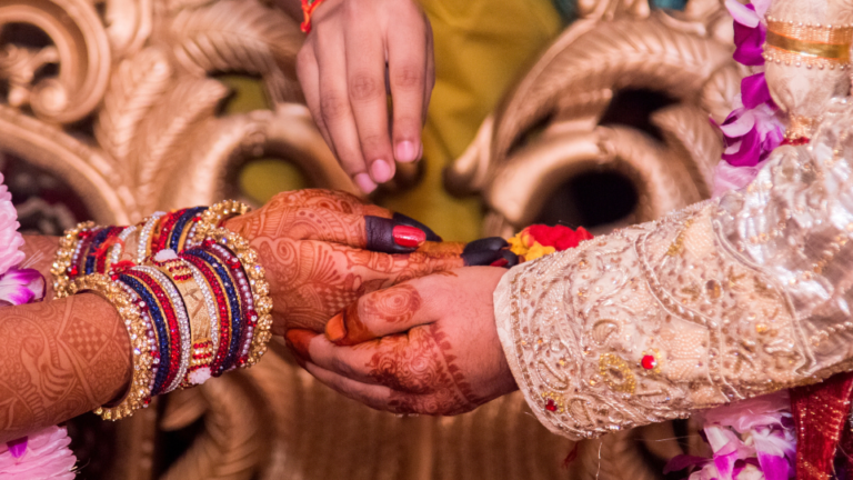 Hands of bride and groom at a traditional Indian wedding