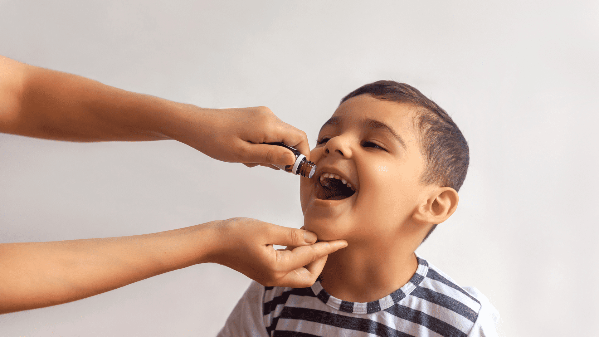 administering of polio liquid mouth drip vaccine to child