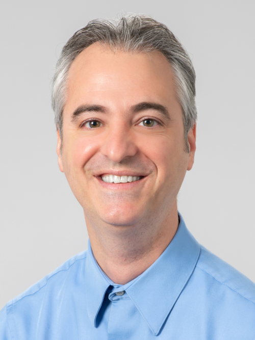Dr. Kirk Scirto, man in blue shirt on gray background