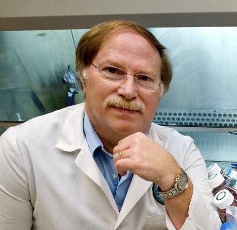 Dr. Robert Garry in a white lab coat