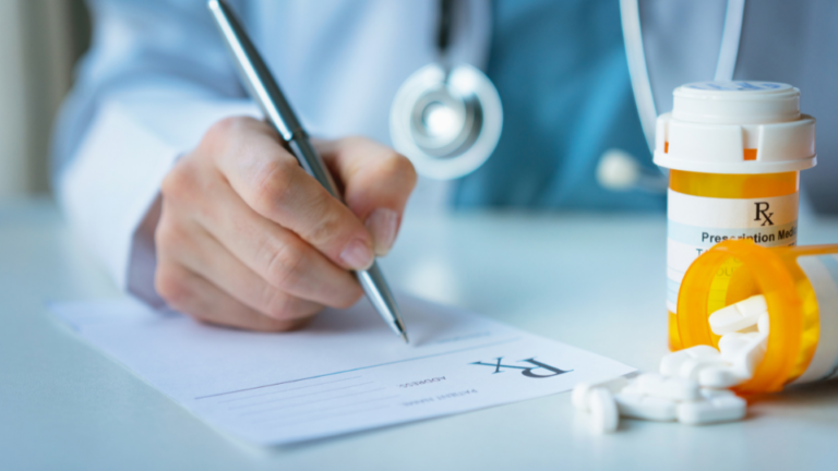 Hand of a doctor writing a prescription