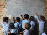 Children drawing on a chalk board