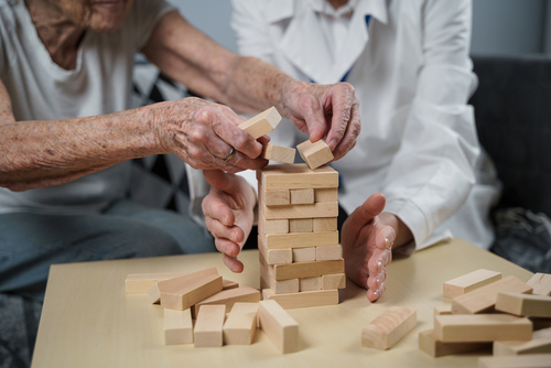 Doctor playing jenga with elderly patient