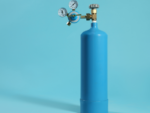 Blue medical oxygen tank over light blue background