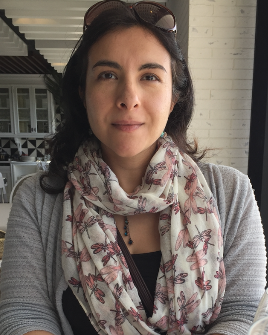 Woman with scar in front of neutral background