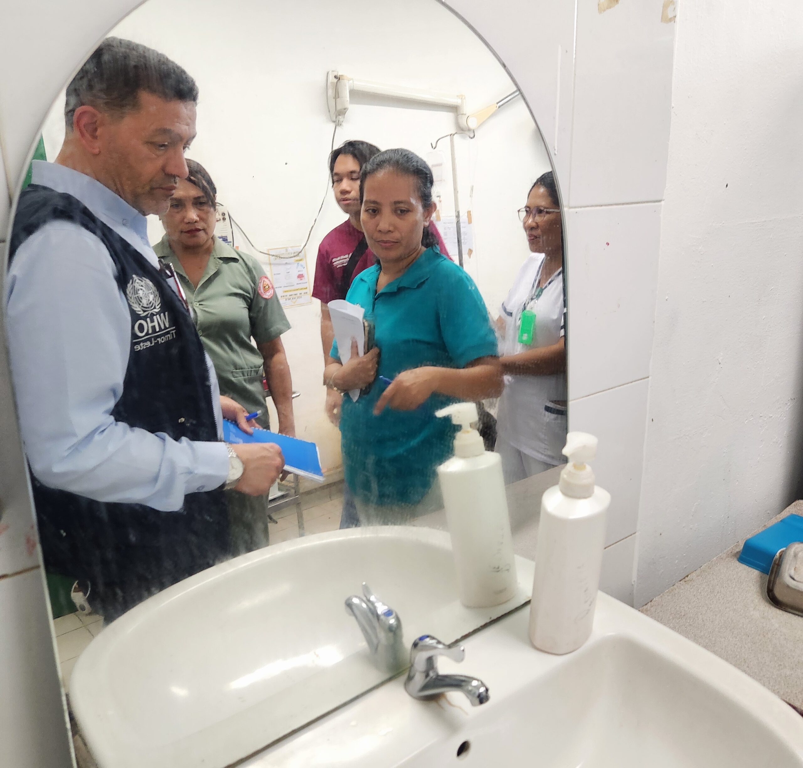 Members of the visiting team in discussion with facility staff during a hospital visit in Dili