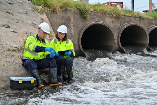 people taking wastewater samples