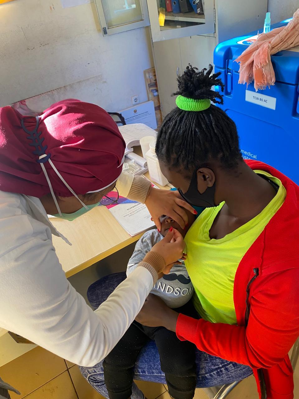 Giving a baby a vaccine in Maputo